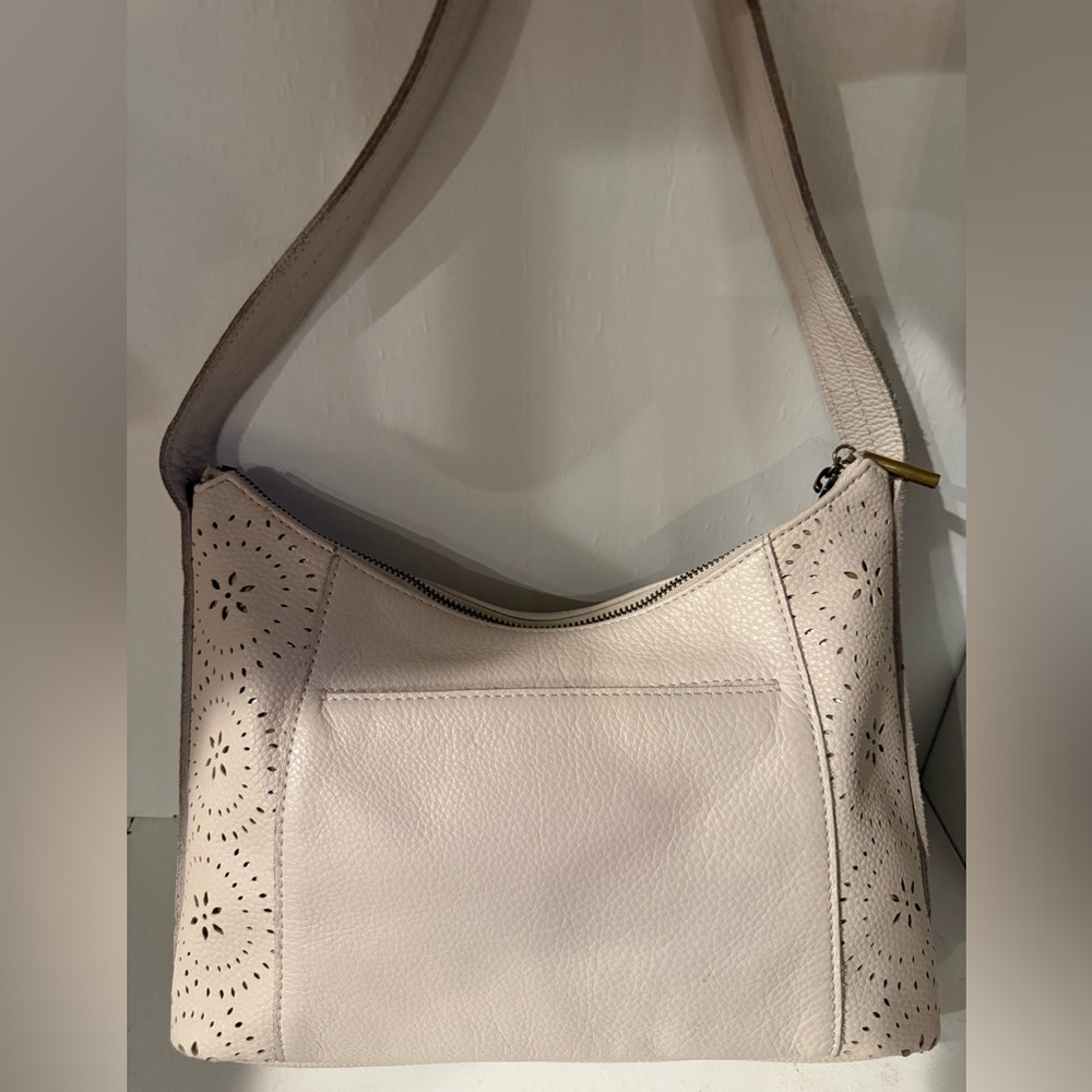 The Sak Elegant Cream Shoulder Bag with gold under the cut outs